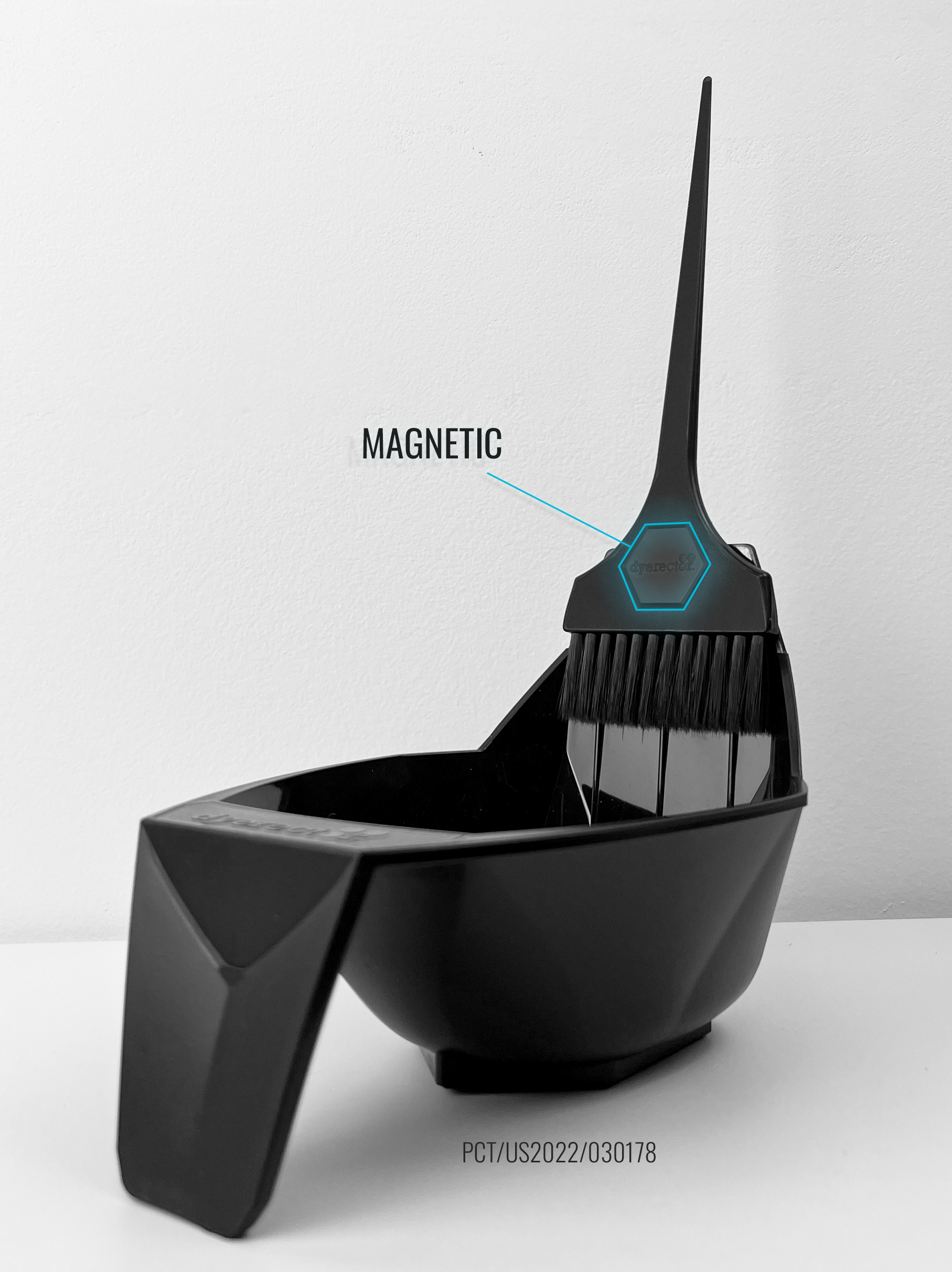Black magnetic hair color bowl that is holding the brush out of the bowl by magnets.